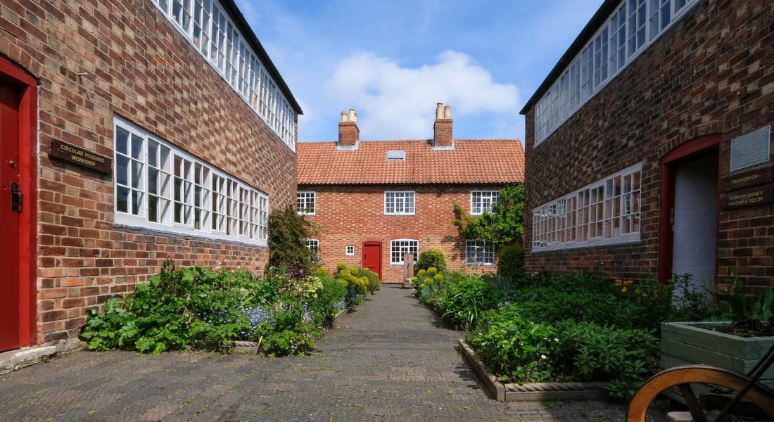 Ruddington Framework Knitters Museum - a brick building house with buildings to the left and right of it Ruddington Framework Knitters Museum - a brick building house with buildings to the left and right of it