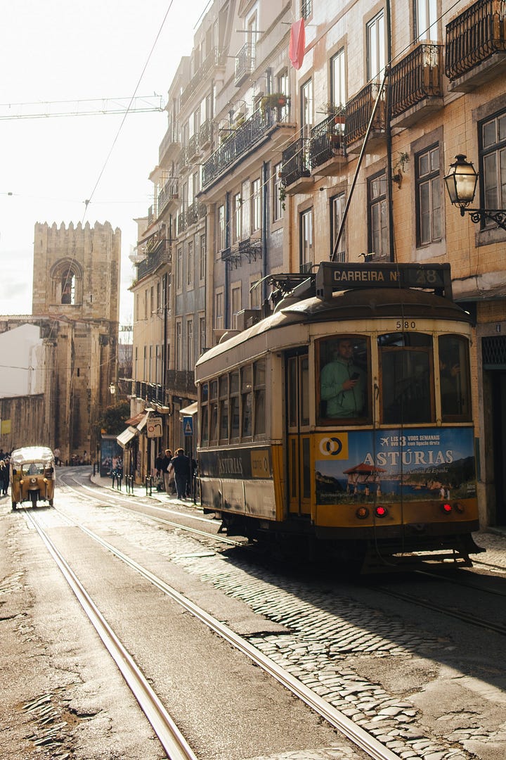 Yellow trams on the streets of Alfama, Lisbon
