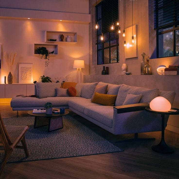 This may contain: a living room filled with furniture and lights