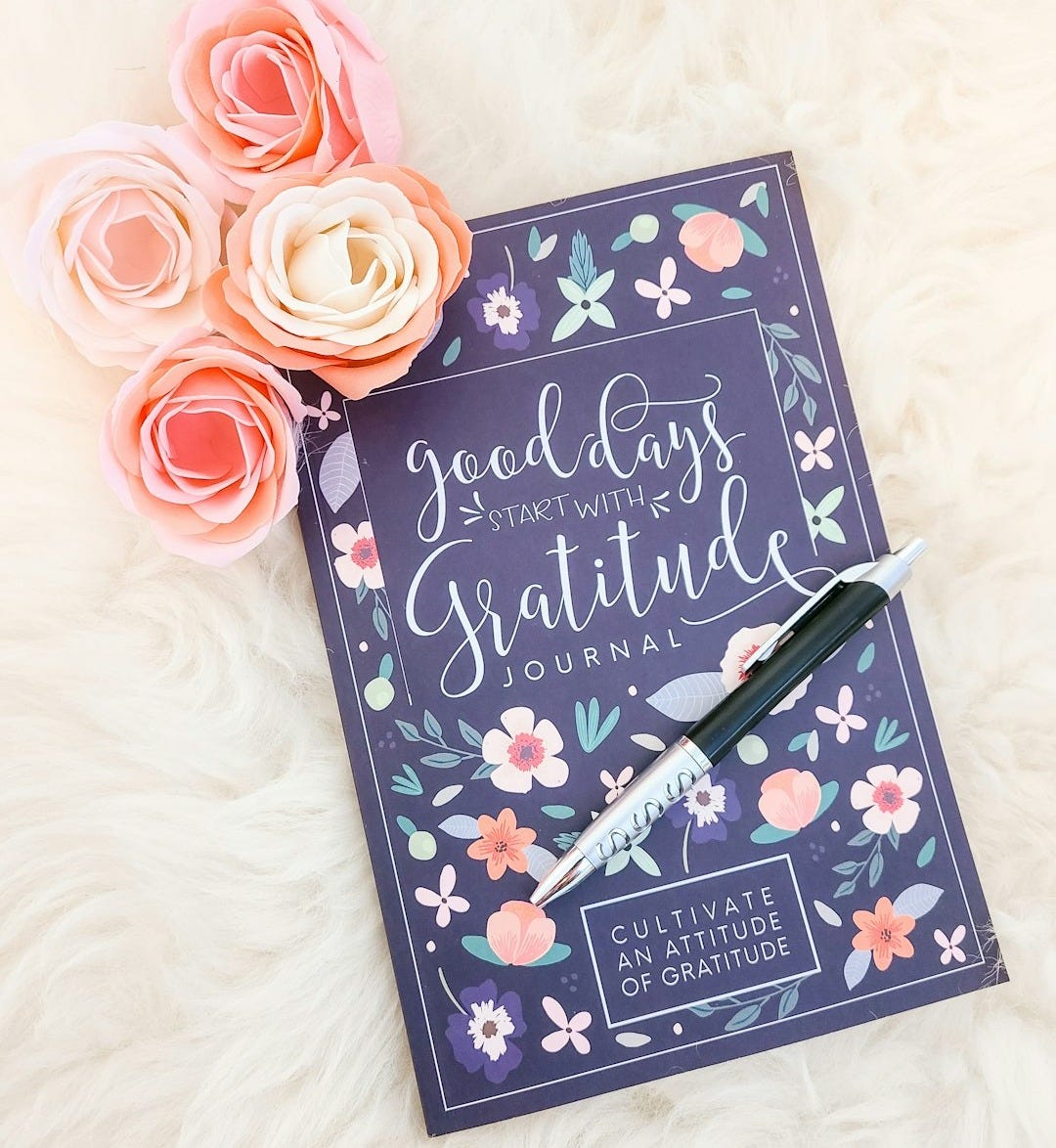 a book with a pen on top of it a book with a pen on top of it