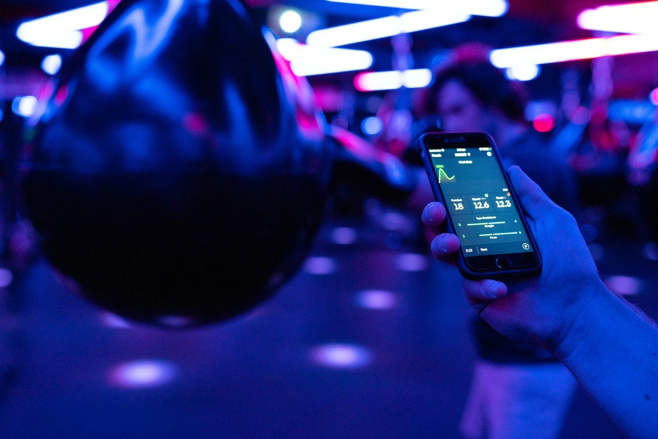 A person holding their phone tracking their exercise A person holding their phone tracking their exercise