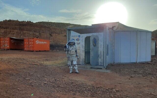 An Israeli analog astronaut in a simulated spacesuit exits the Mars habitat in the Ramon Crater in the Negev on October 31, 2021. (Amy Spiro) An Israeli analog astronaut in a simulated spacesuit exits the Mars habitat in the Ramon Crater in the Negev on October 31, 2021. (Amy Spiro)