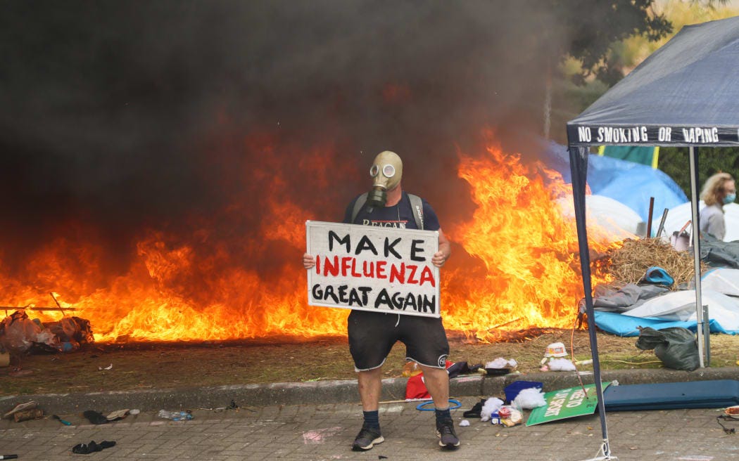 Make influenza great again protester with gas mask in front of fire Make influenza great again protester with gas mask in front of fire