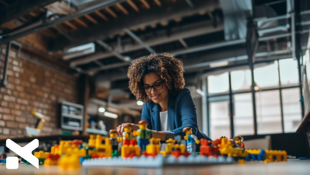 woman-executive-illustrating-building-a-team-using-legos-the-executive-designer-blog