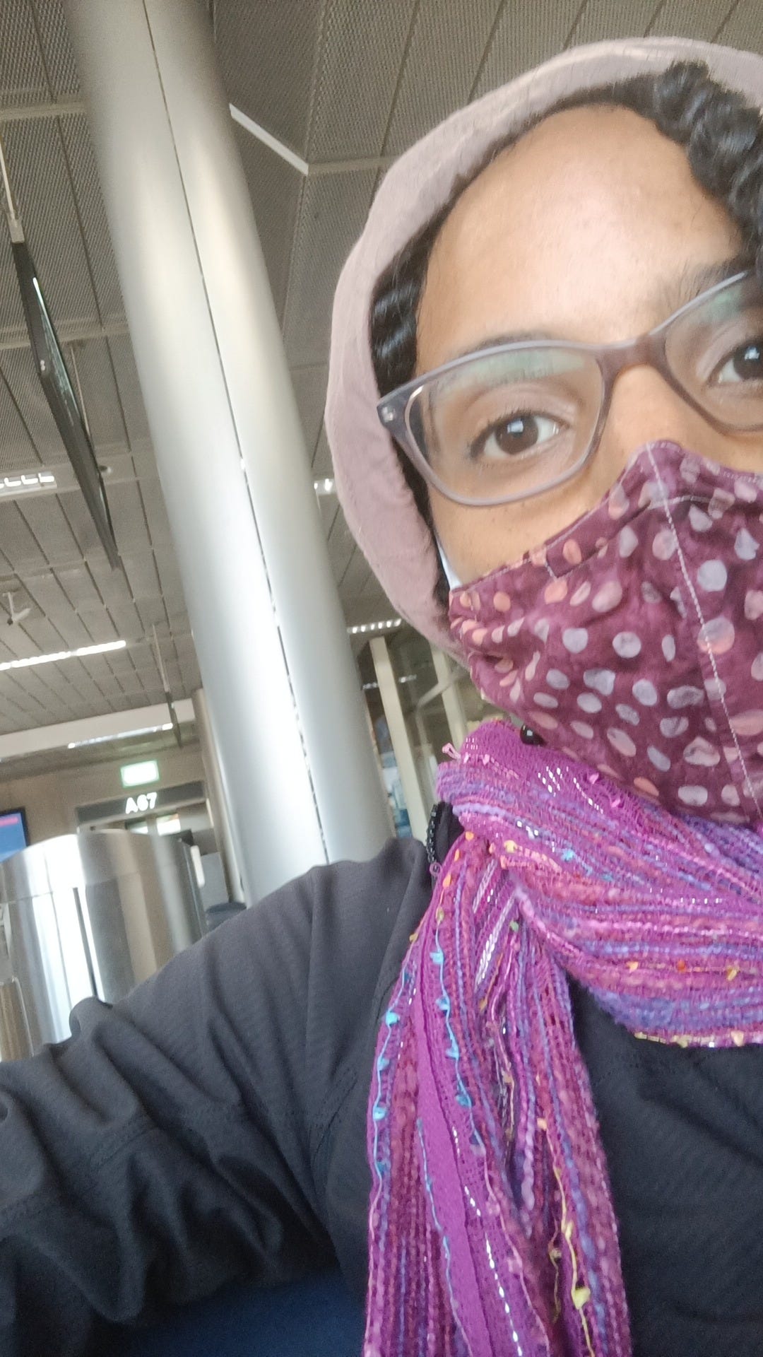 Laia sitting at the Zurich Airport