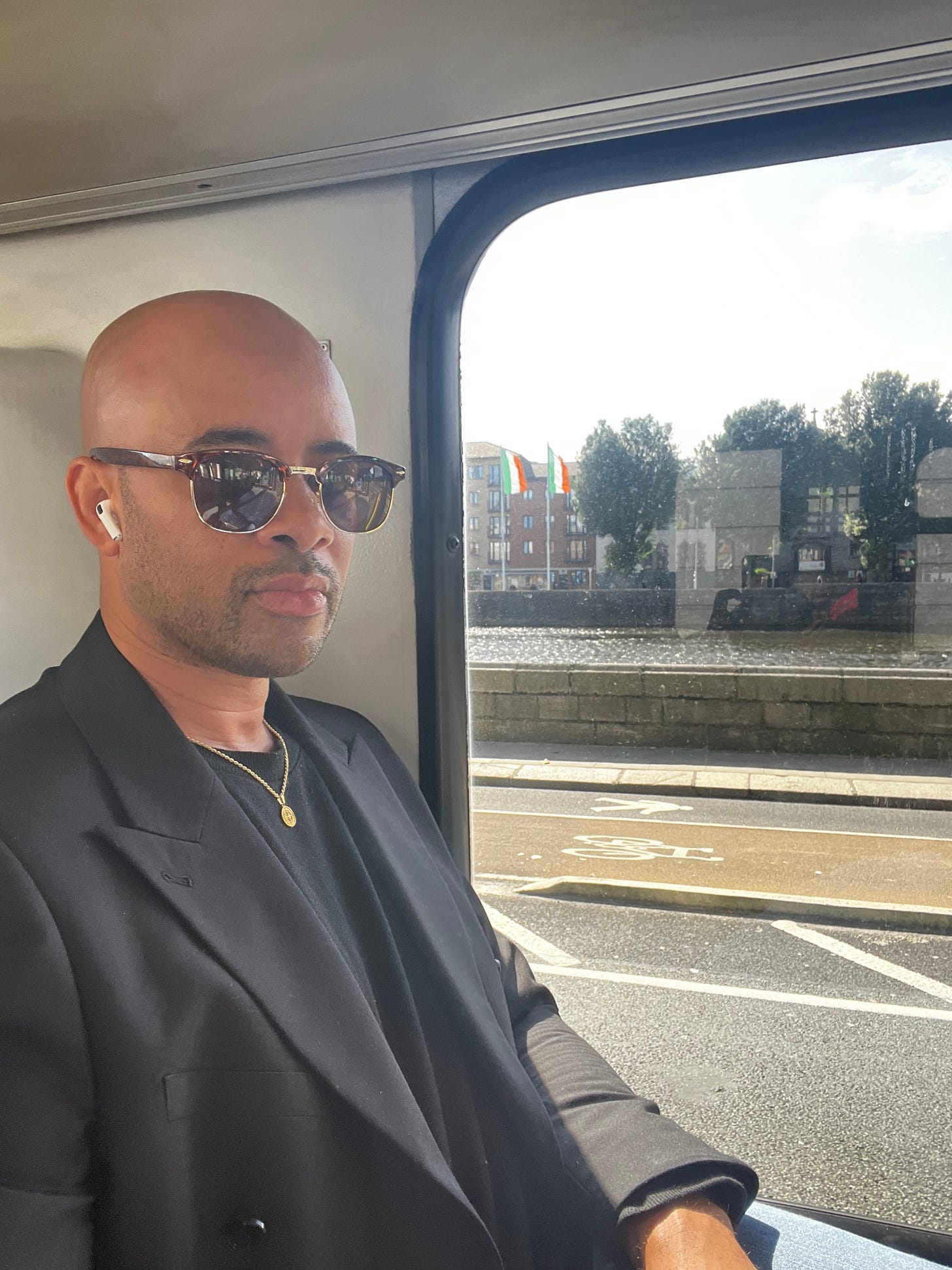 Ethan Ward sitting by a bus window in Dublin with Irish flags visible across the river. Ethan Ward sitting by a bus window in Dublin with Irish flags visible across the river.