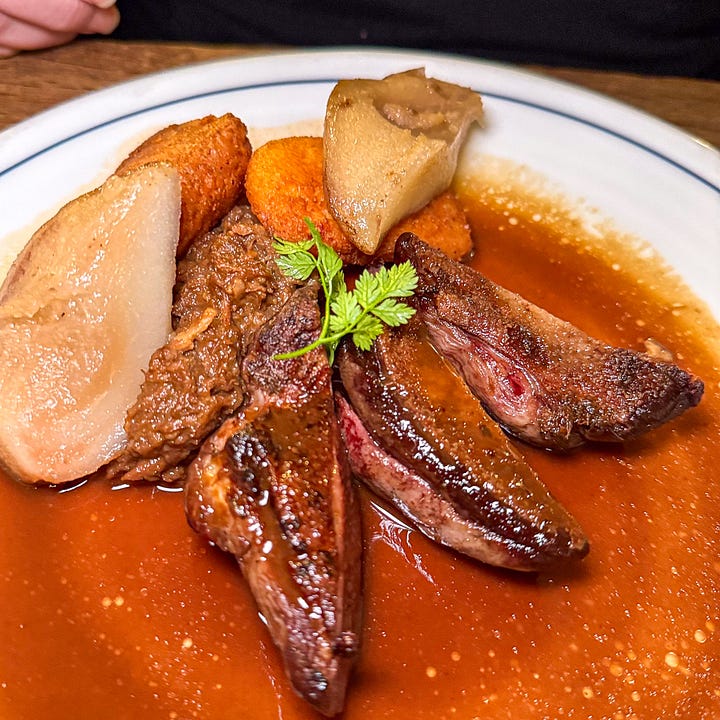 Tournedos Rossini at Le Bon Georges — filet mignon with seared foie gras and shaved black truffles and also wild duck with pear