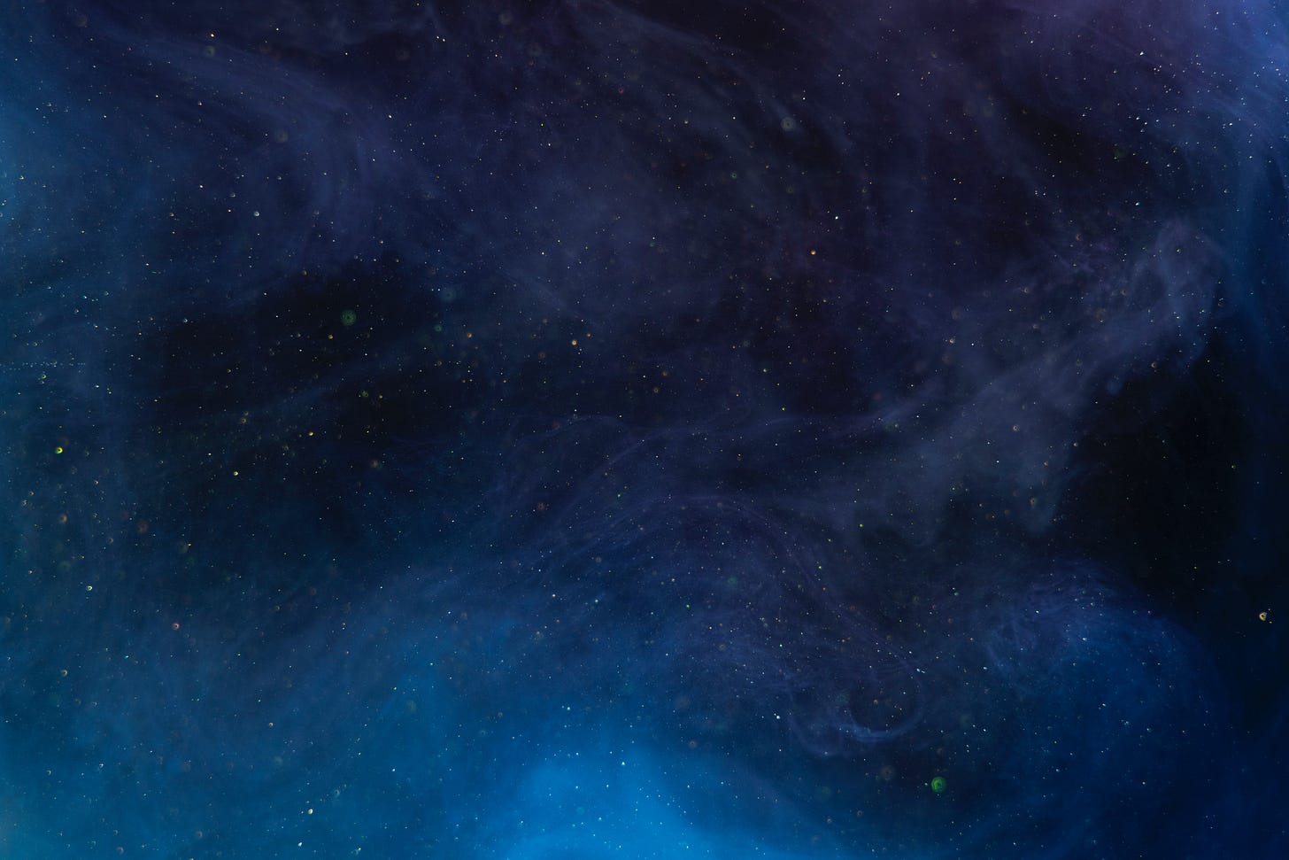 A purple and blue starry sky transposed with swirling mist