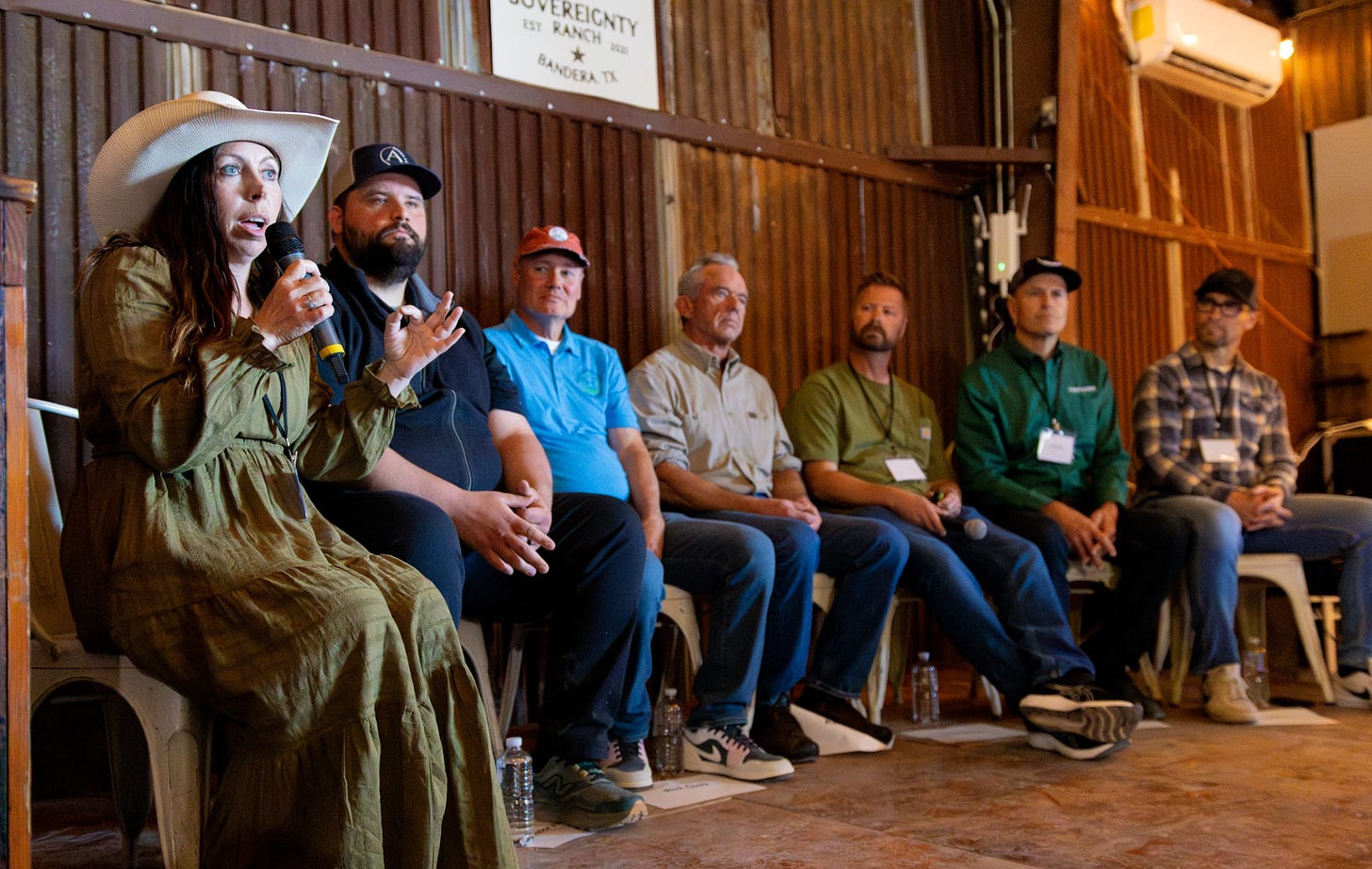 Mollie Engelhart in a wide-brimmed hat and olive dress speaks into a microphone alongside fellow panelists at the ranch.