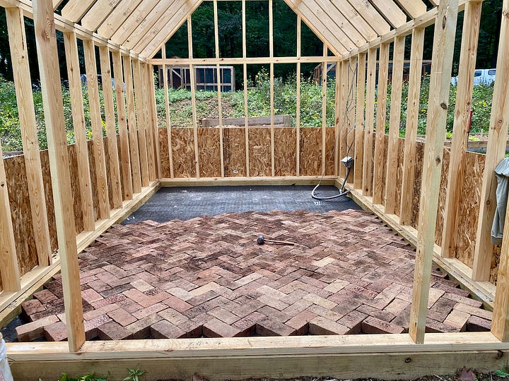 Mosaic of a brick paver floor being installed.