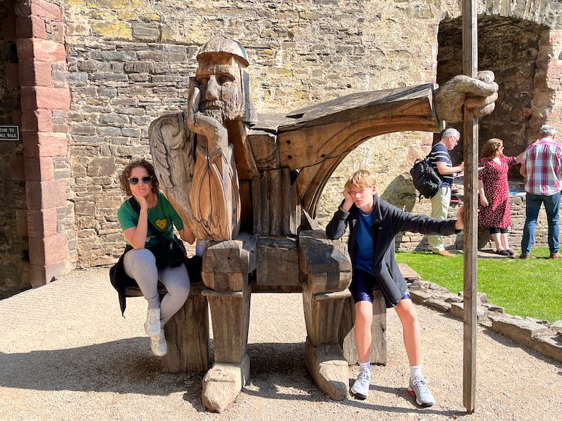 2025-6-19 Becky and Hudson with the bored guard sculpture at Conwy Castle, Wales