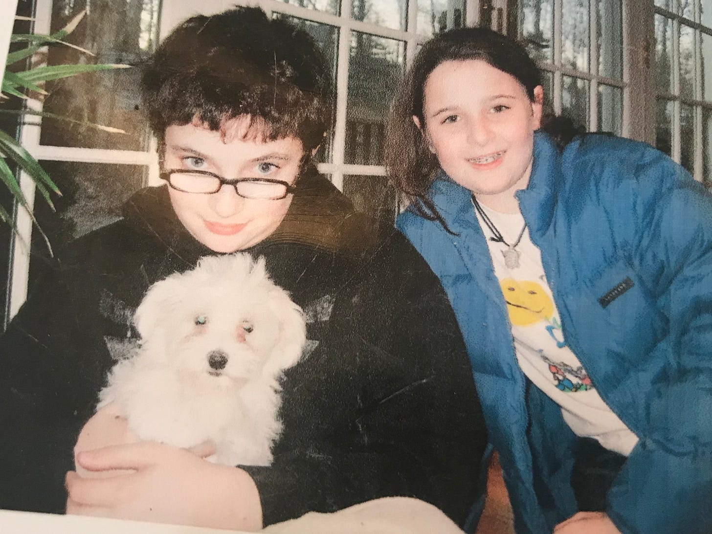 Boy with glasses and girl with braces and their new Havanese puppy