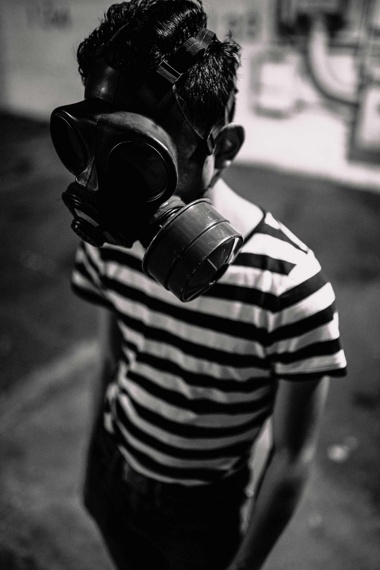 Person wearing a gas mask looking away, representing why Gen X distrusts artificial intelligence and fears AI job replacement Person wearing a gas mask looking away, representing why Gen X distrusts artificial intelligence and fears AI job replacement