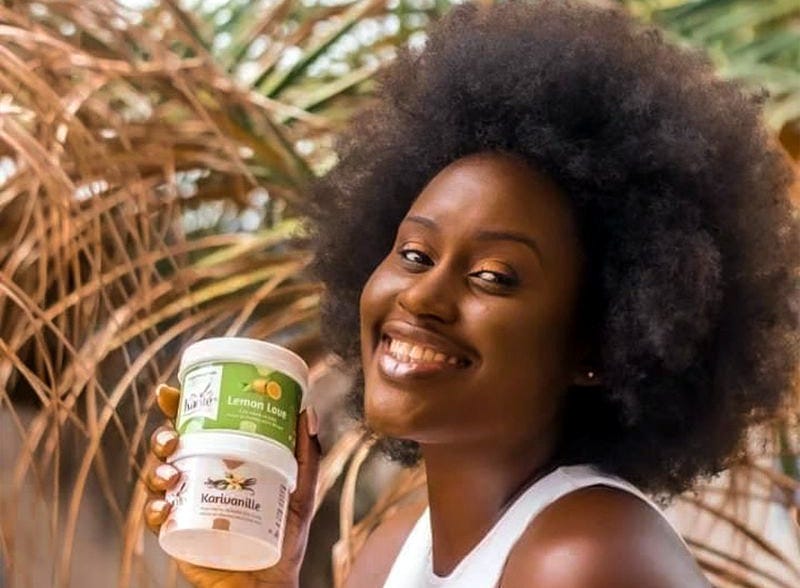 Mouahié Kouassi, founder of Agrikraft posing for a picture while holding her products. Mouahié Kouassi, founder of Agrikraft posing for a picture while holding her products.