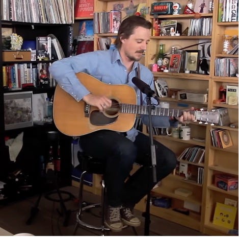 A person playing guitar in a room

AI-generated content may be incorrect.