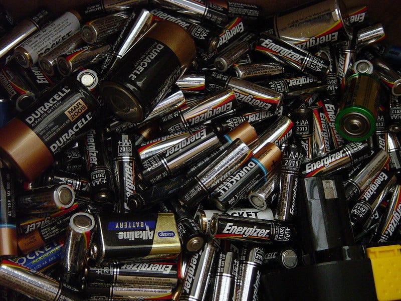 color photo of a big pile of discarded small batteries (AA, D, C, and 9-volt) at a recycling center color photo of a big pile of discarded small batteries (AA, D, C, and 9-volt) at a recycling center