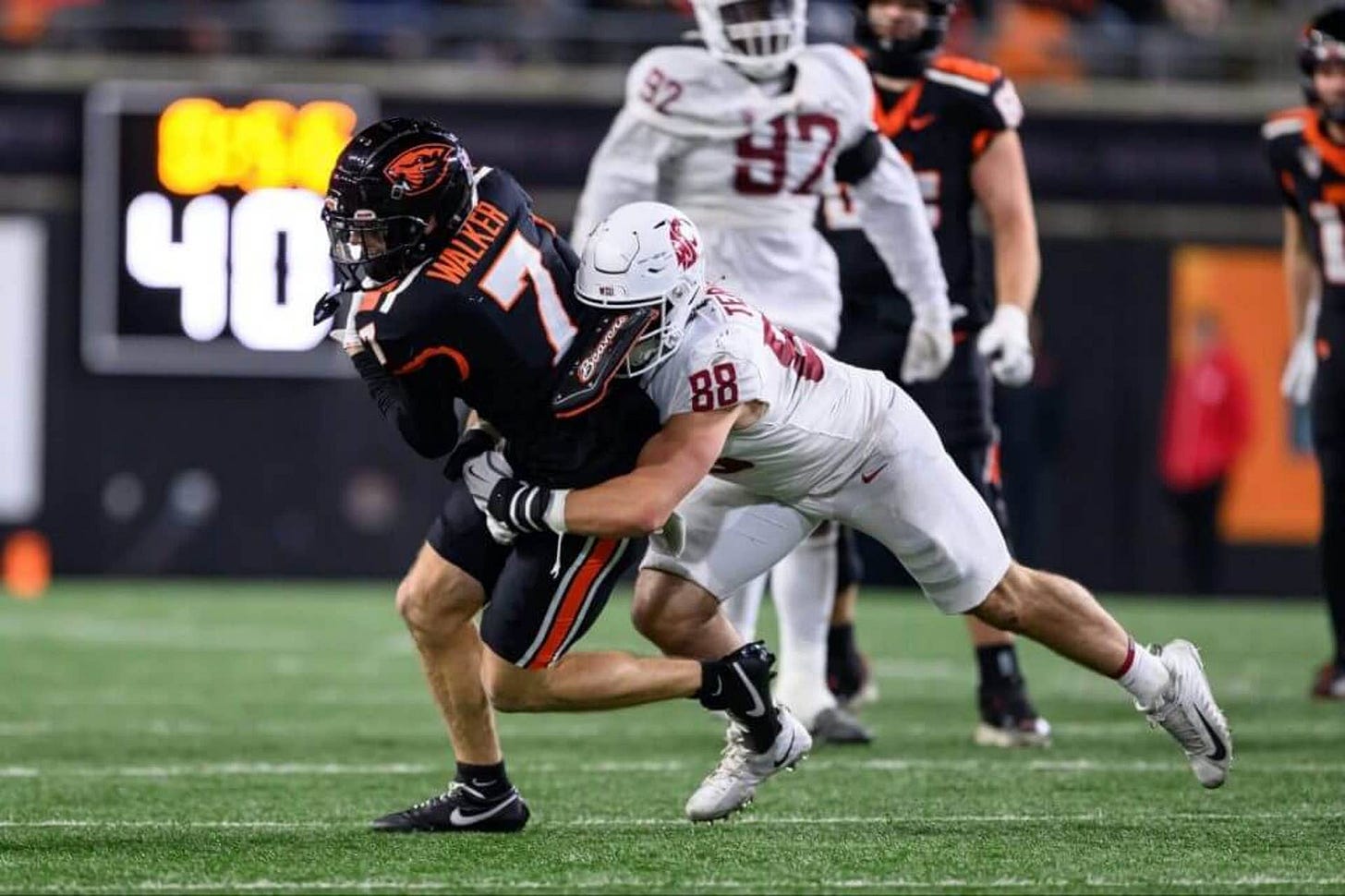 Nov 23, 2024; Corvallis, Oregon, USA; Oregon State Beavers wide receiver Trent Walker (7) catches a pass and is tackled by Washington State Cougars edge Isaac Terrell (88) during the fourth quarter at Reser Stadium. Mandatory Credit: Craig Strobeck-Imagn Images