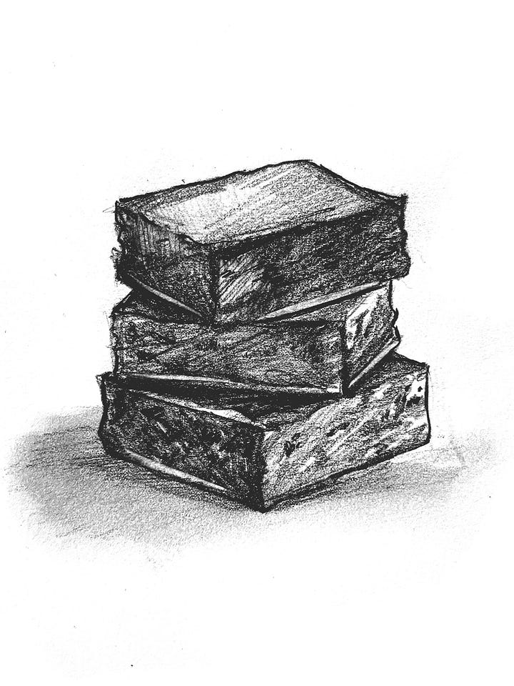 Black and white sketches of a three brownies in a stack, and a cake with a meteor on it