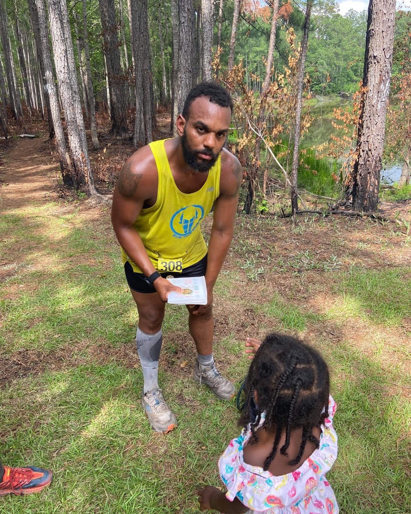 May be an image of 2 people, child, people standing and outdoors