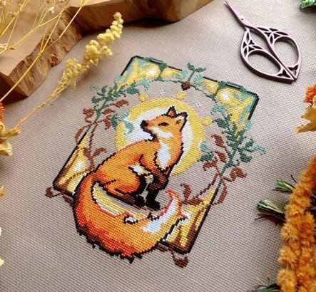  cross stitch pattern in the style of art nouveau.  A majestic fox sits, looking to the side, surrounded by art nouveau elements and foliage.