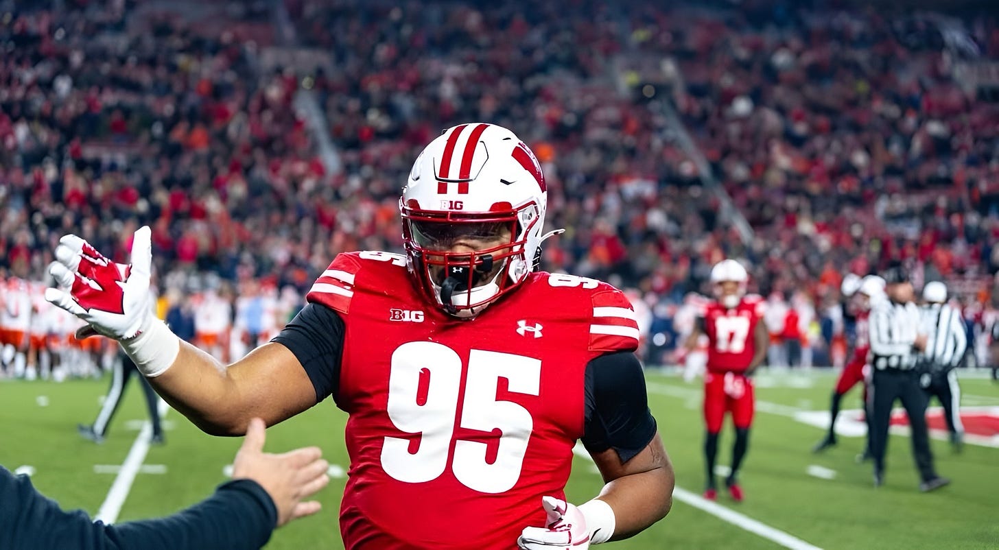 Wisconsin Badgers defensive lineman Brandon Lane runs toward the sideline during a game.