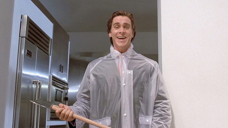 a still from American Psycho showing Christian Bale as Patrick Bateman dressed in a raincoat holding an axe about to murder his boss with a big smile a still from American Psycho showing Christian Bale as Patrick Bateman dressed in a raincoat holding an axe about to murder his boss with a big smile