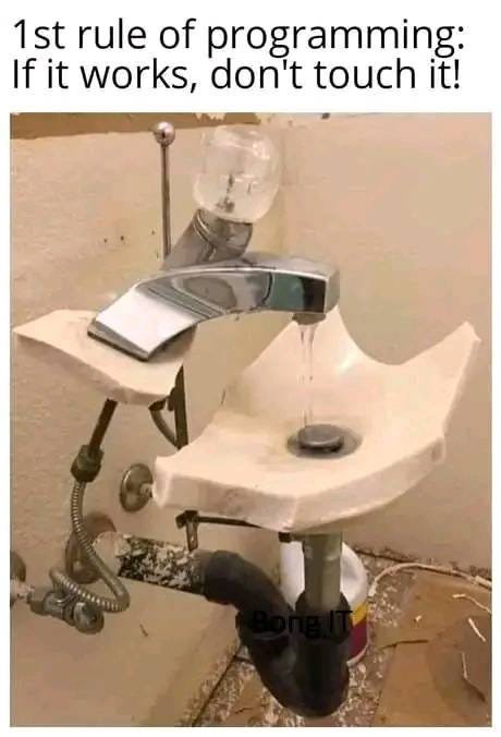 May be an image of indoor and text that says '1st rule of programming: If it works, don't touch it!'