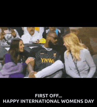 a group of people are sitting in a stadium and one of them is wearing a jersey that says ynwa .