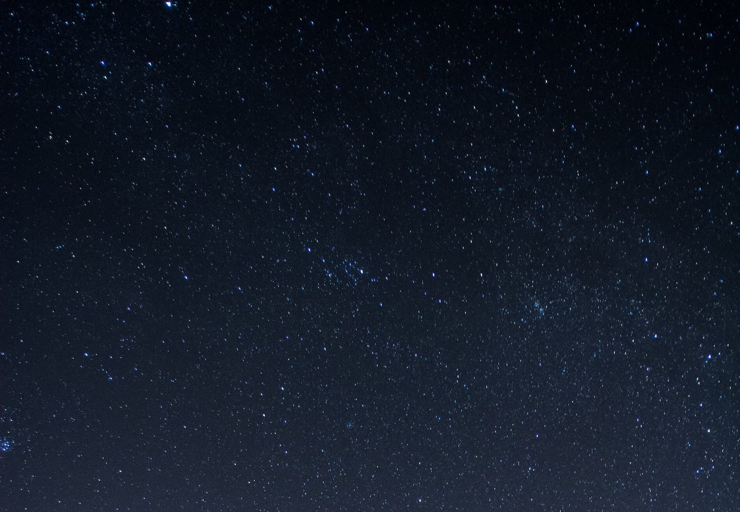 Image is of a dark night sky full of stars