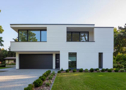 A square, white house with a flat roof