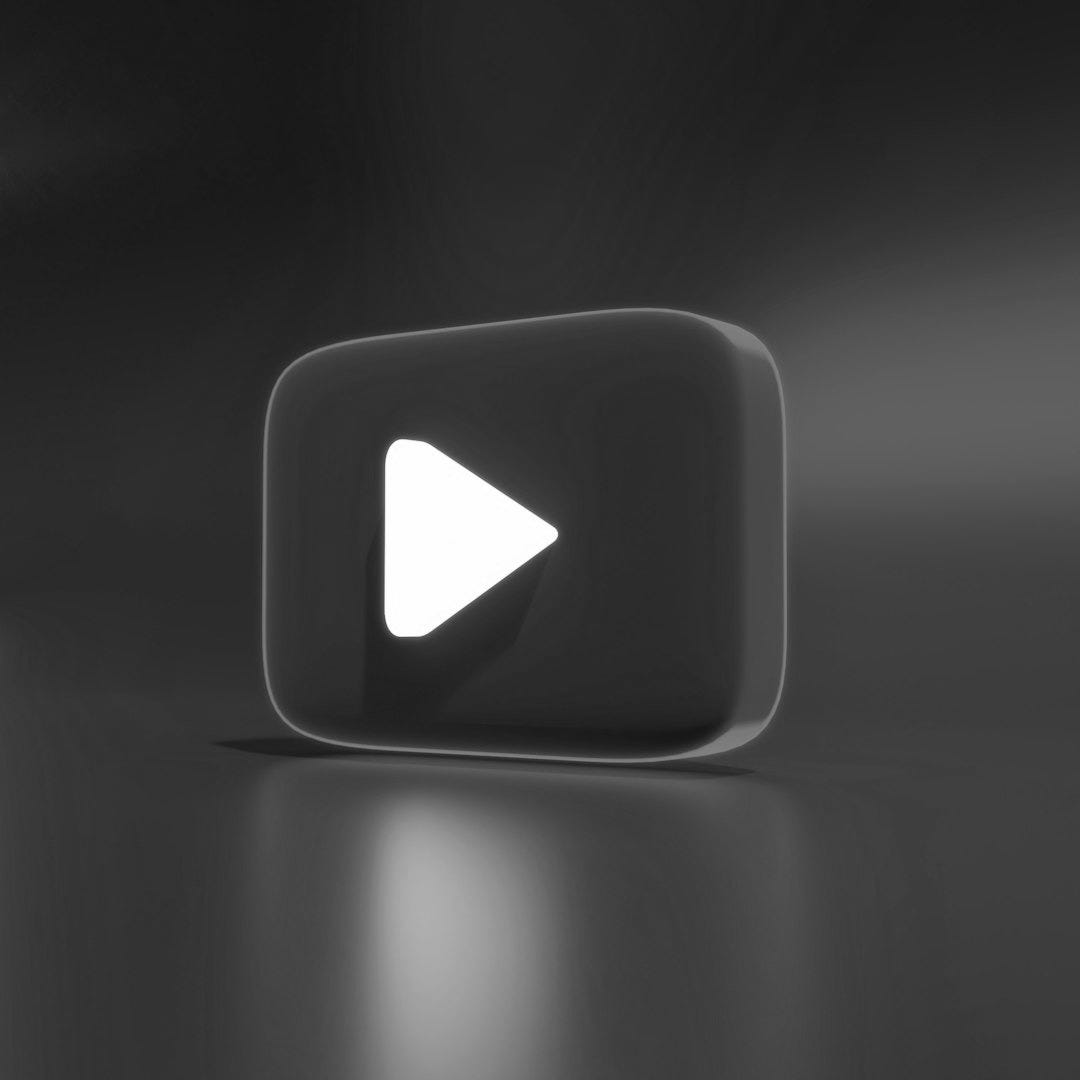 a red play button sitting on top of a table a red play button sitting on top of a table