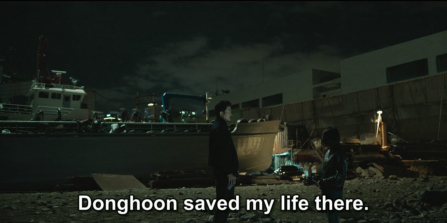 Choi Mu-jin with Yoon Ji-woo at a rundown warehouse, episode two of My Name (2021) with the line "Dong-hoon saved my life there."
