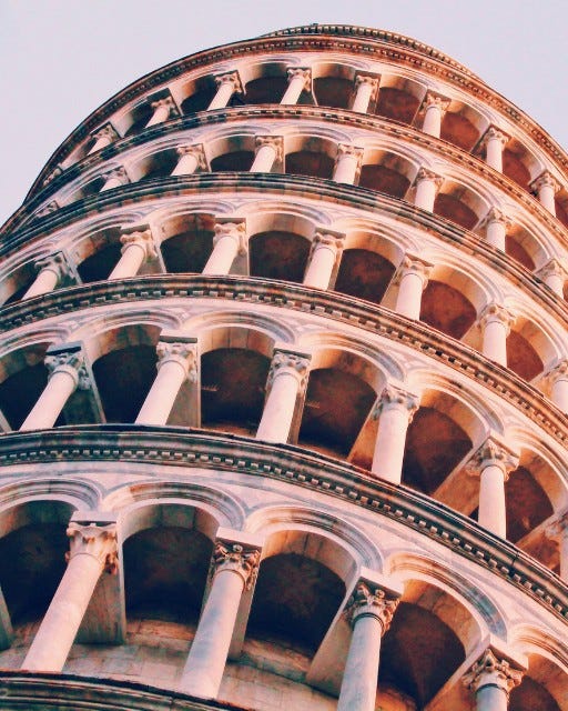 May be an image of the Leaning Tower of Pisa and bell tower