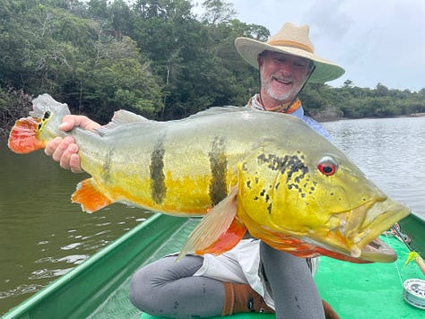 angler with large permit standing in the water