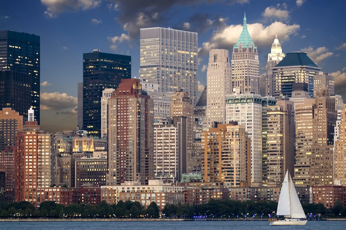 Free Cityscape during Nighttime Near Body of Water and Sail Boat Stock Photo Free Cityscape during Nighttime Near Body of Water and Sail Boat Stock Photo