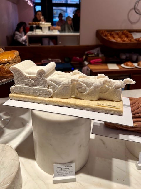 Yule logs: a white dog-drawn sled and a traditional log.