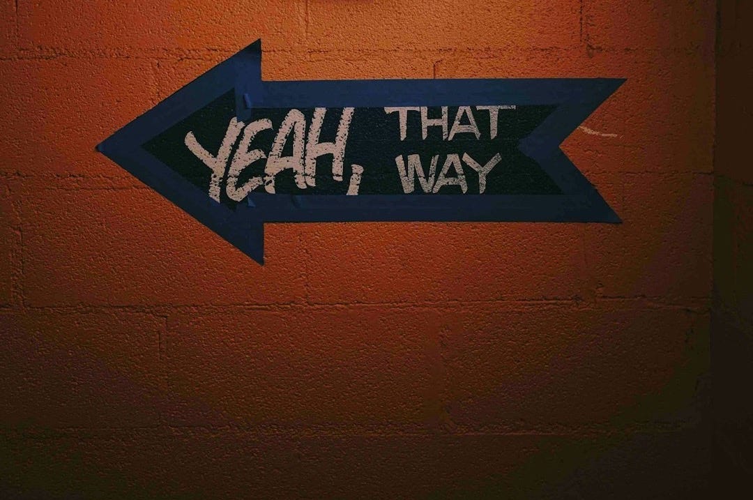 blue and black arrow signage