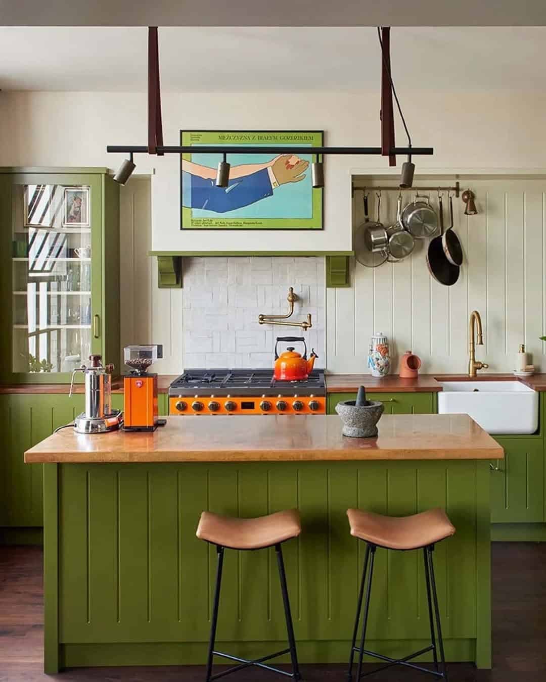 A vibrant green kitchen with oak countertops and a delicious orange stove. small kitchen design mistakes.