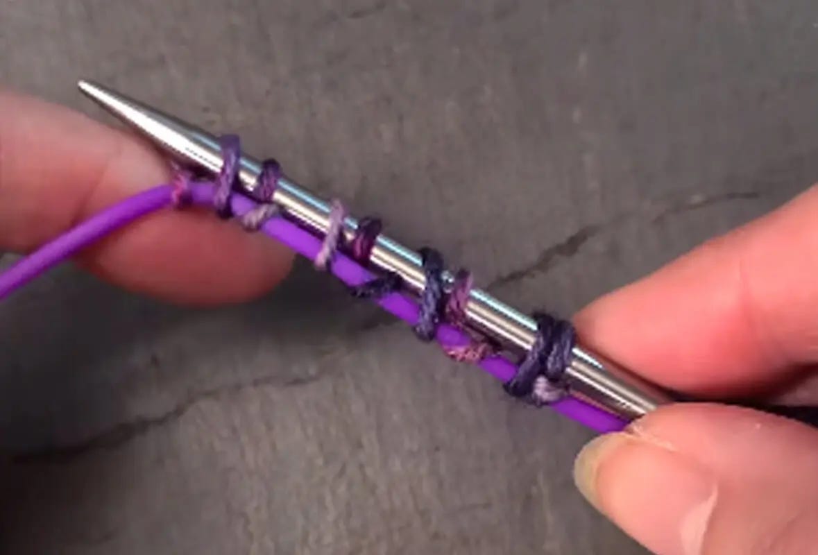 hand holds needle with provisional cast-on