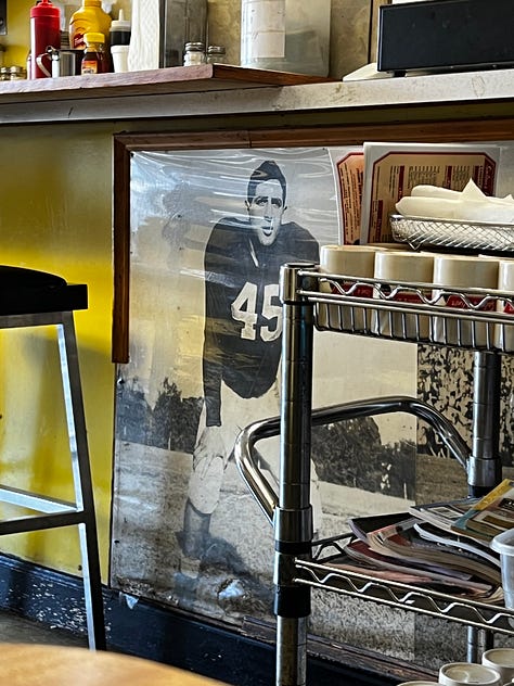 the Mike Slive table plaque, pictures of football players on a diner wall