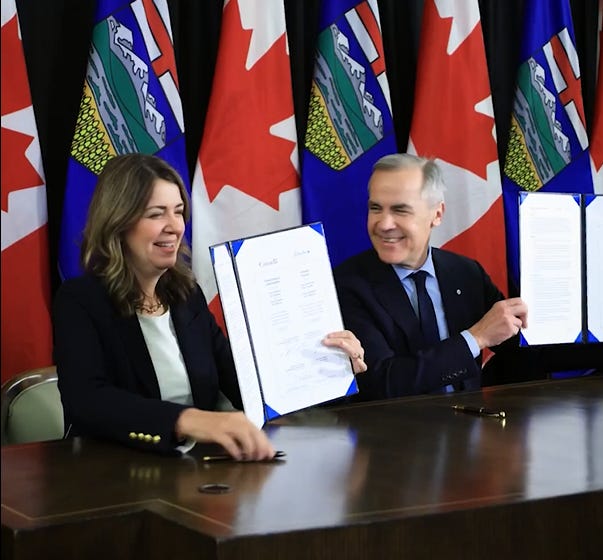 Mark Carney and Danielle Smith hold up a signed agreement