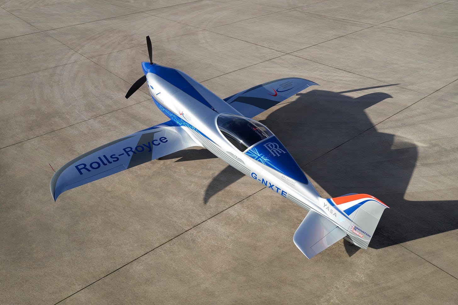 Image of the Rolls Royce Spirit of Innovation electric propeller aircraft, setting on a concrete apron area on a bright sunny day. Image of the Rolls Royce Spirit of Innovation electric propeller aircraft, setting on a concrete apron area on a bright sunny day.