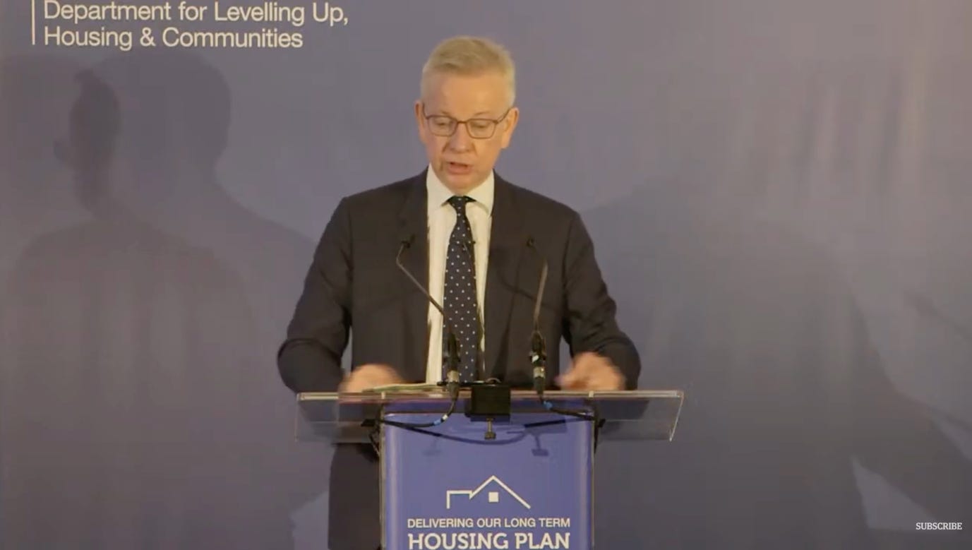 A person standing at a podium

Description automatically generated