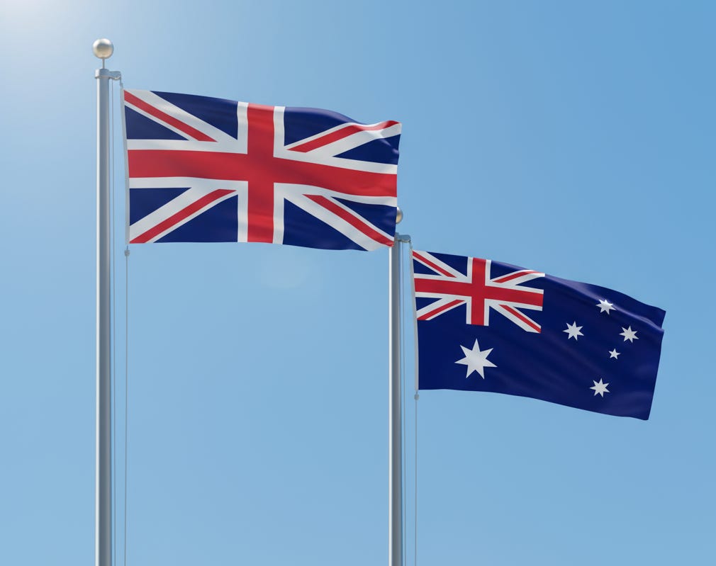 British Union Jack and Australian flag on flagpoles together British Union Jack and Australian flag on flagpoles together