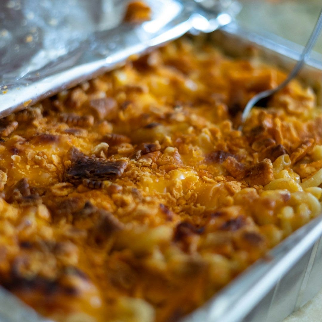 a dish of macaroni and cheese with a spoon in it