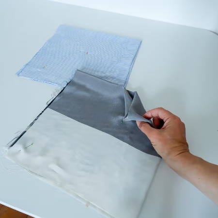 showing the fold and the center corner of the square fabric piece showing the fold and the center corner of the square fabric piece