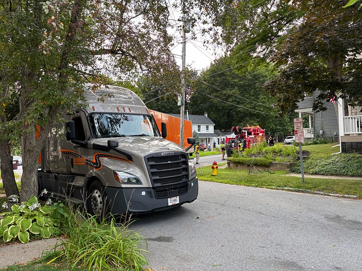 Picture of an 18 wheeler tractor trailer and a large tow truck.