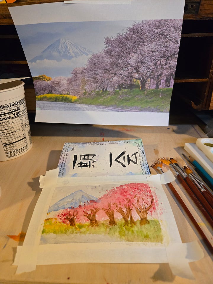 Watercolor sketchbook spread of Mount Fuji and cherry blossoms, paired with Japanese calligraphy and practice sketches inspired by Japan.