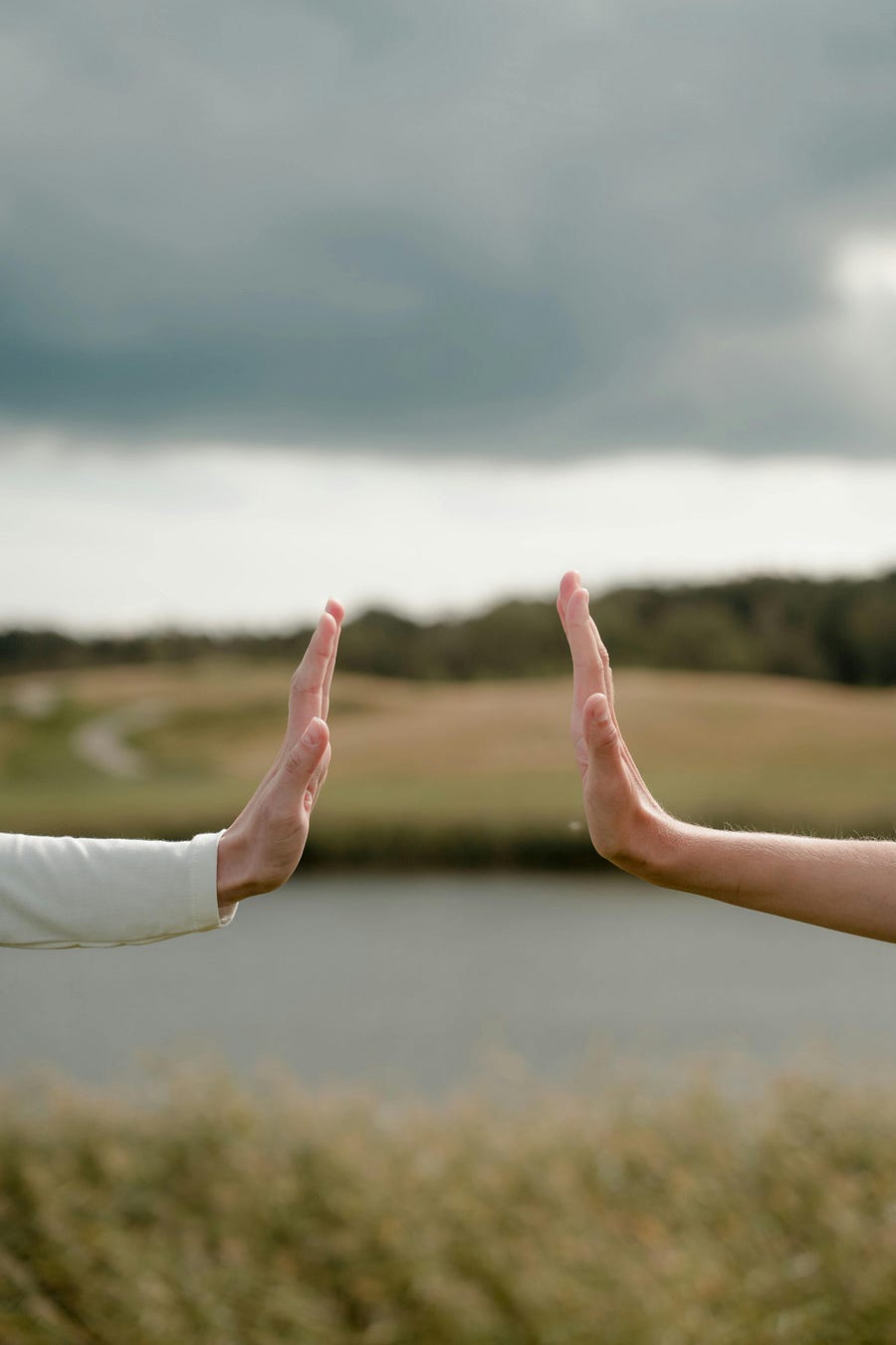 Two hands held up facing each other with space in between Two hands held up facing each other with space in between