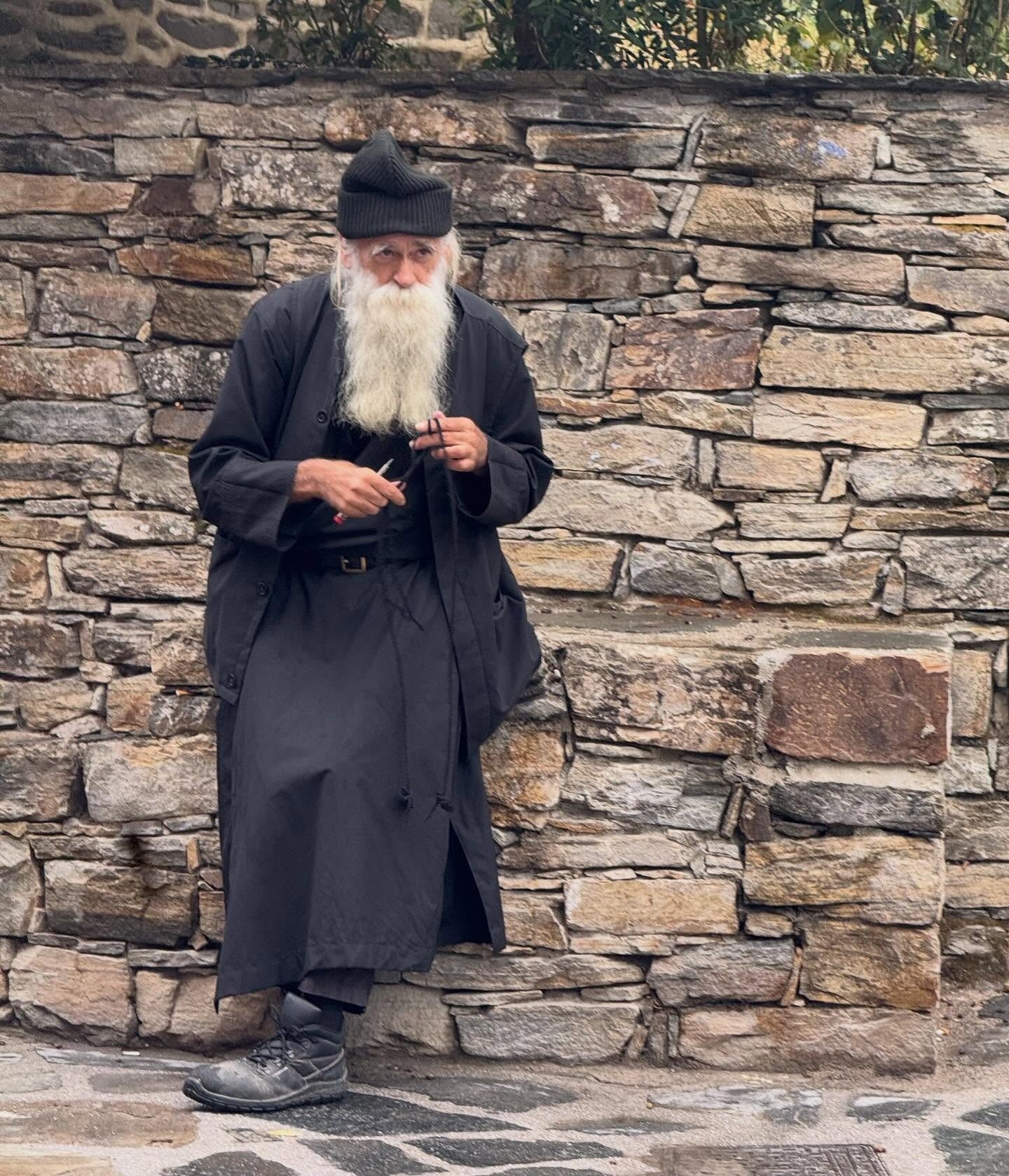 May be an image of 1 person, overcoat and the Western Wall May be an image of 1 person, overcoat and the Western Wall